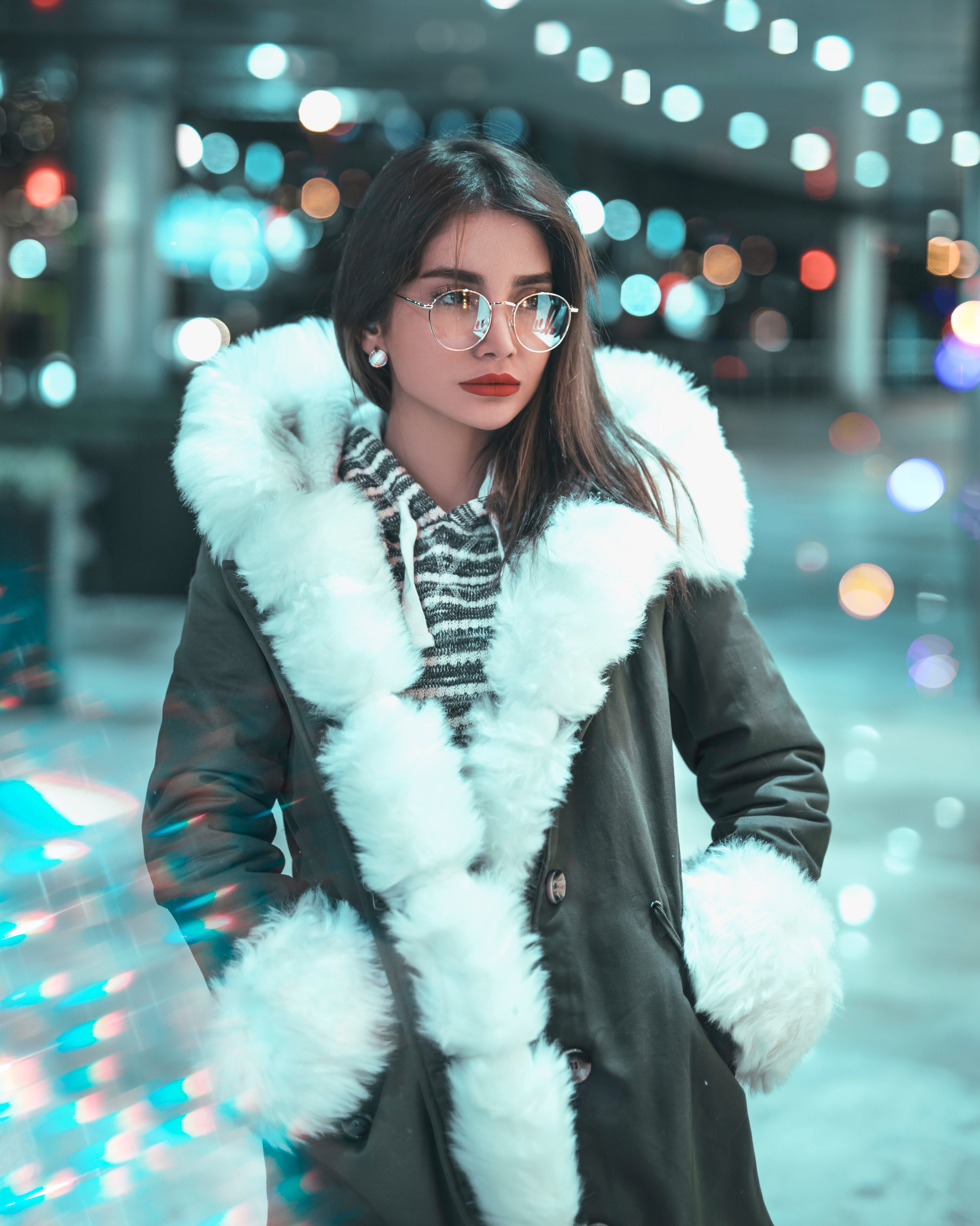 A woman wearing a fur coat and glasses 