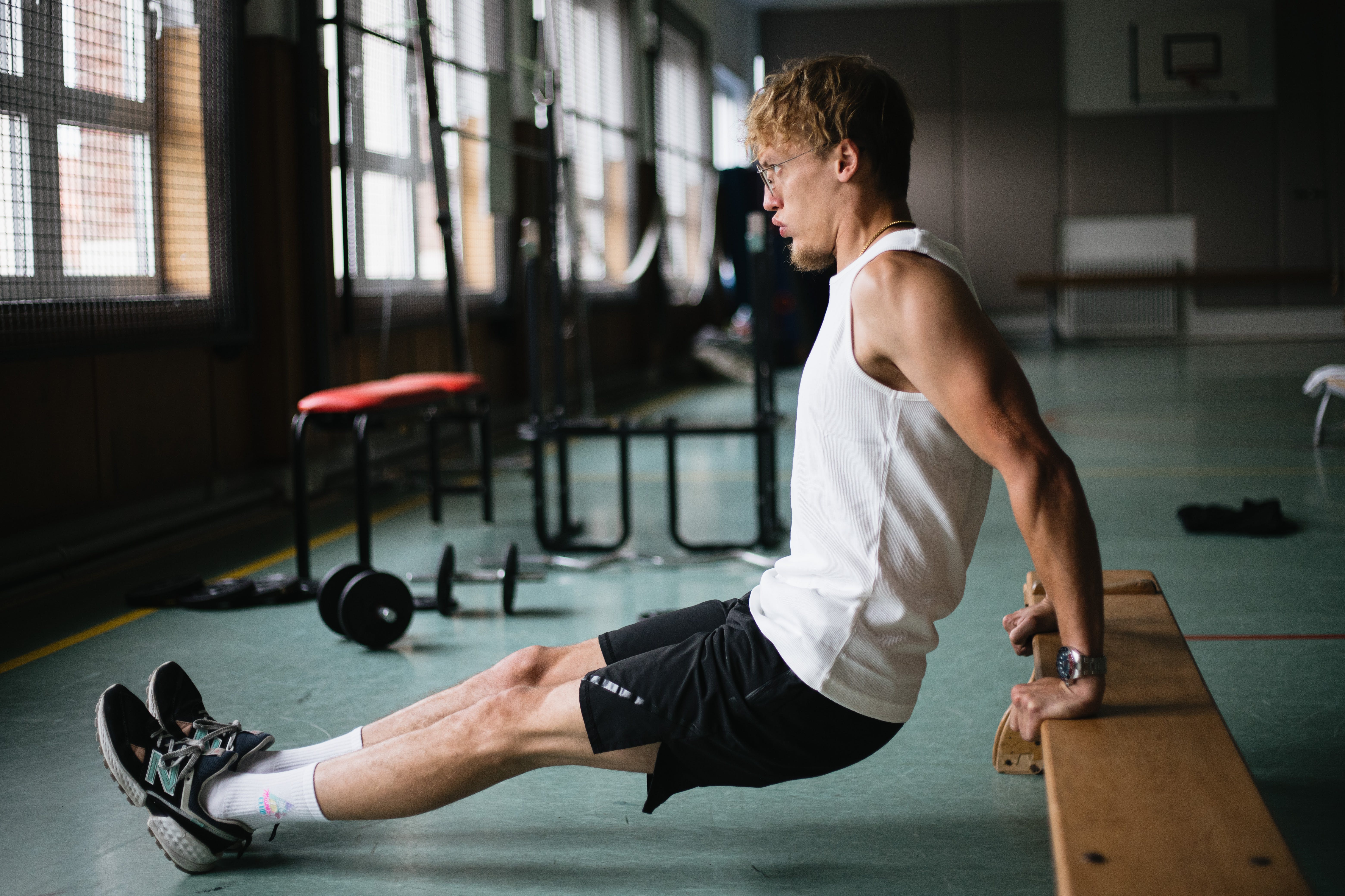 A man wearing glasses working out